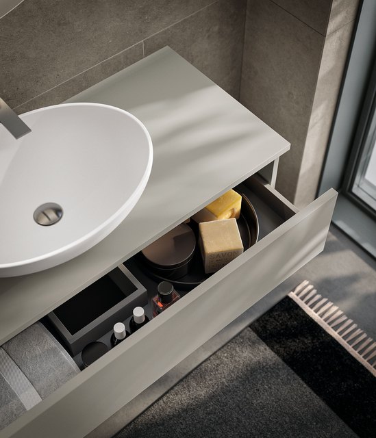 Lavabo ovale d'appoggio con cassetto portaoggetti